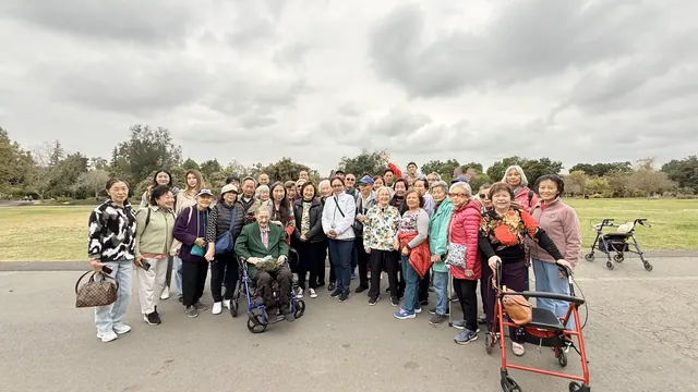 Group photo of residents at a park during an outing