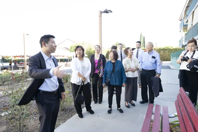 Guests touring the outdoor walkway of the community