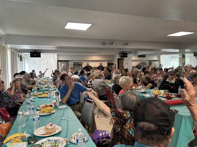 Residents raising their hands during an interactive activity