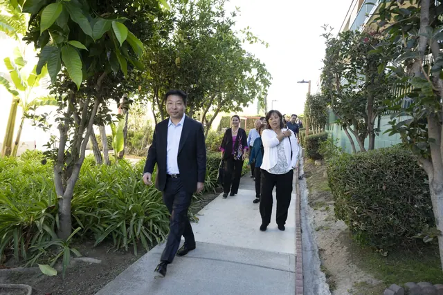 Guests walking along a garden path during a tour of the grounds