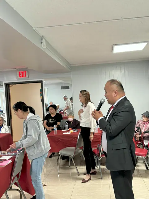 A guest speaking with a microphone at the birthday party