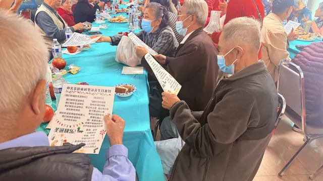 Residents holding song sheets and singing along