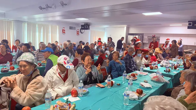 Residents gathered at tables with refreshments for the December birthday party