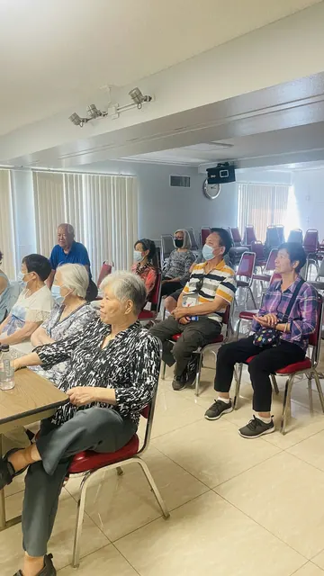 Residents seated in the activity room listening to the seminar