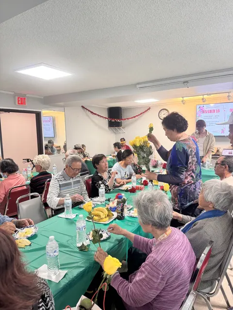 Yellow roses being handed out to the women residents at the celebration