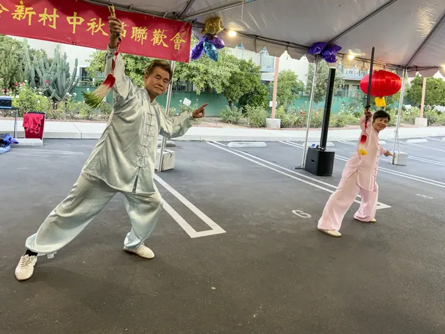 Residents perform a tai chi sword routine