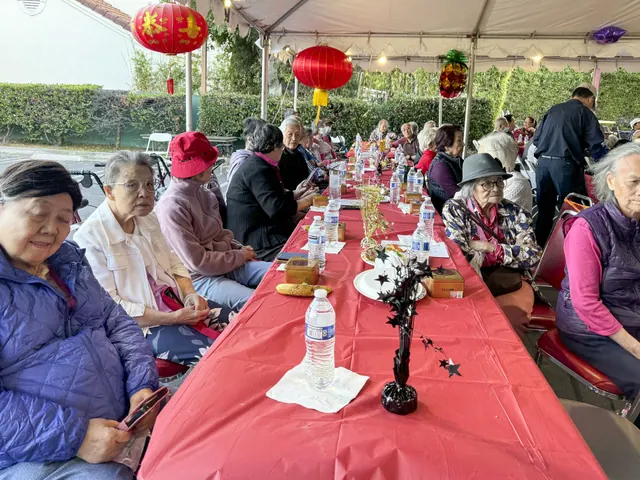 Residents share the Mid-Autumn celebration at long banquet tables