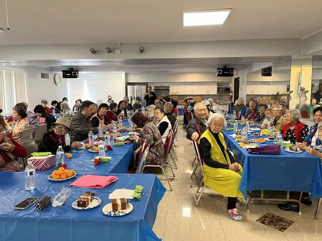 Tables set with cake and tangerines as residents celebrate together