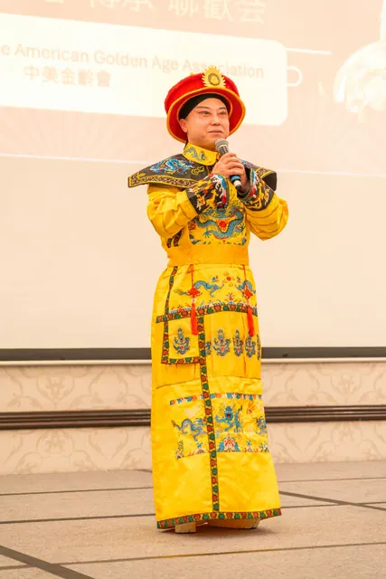 A performer in traditional imperial costume singing on stage