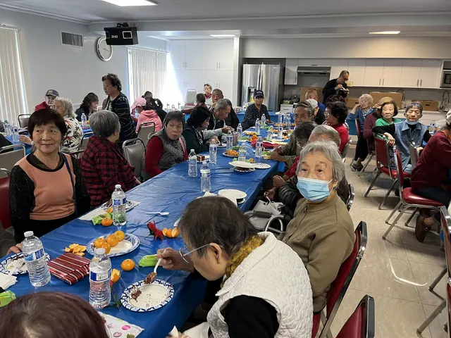Residents enjoying cake and fresh fruit at the birthday party