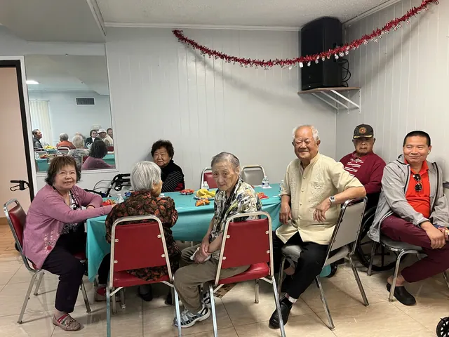 Residents seated around a table at the birthday gathering