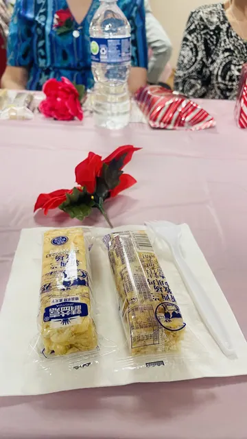 Snacks and a red flower on the party table