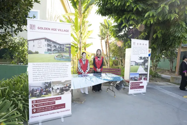 Reception table flanked by Golden Age Village banners at the Mid-Autumn Festival celebration