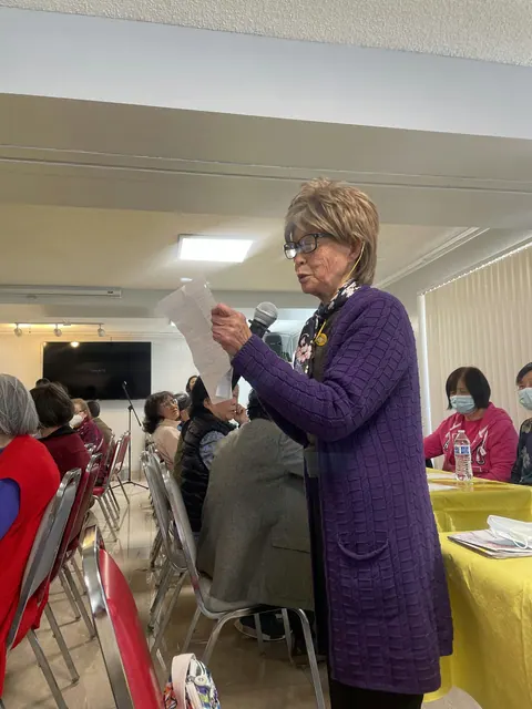 A resident reading from a sheet of paper during the party