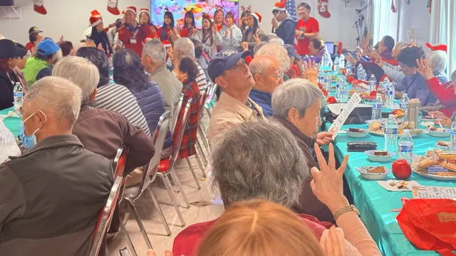 Residents enjoying the performance and raising their hands to join in