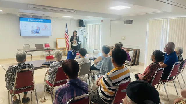 Seniors listen attentively as the presenter speaks at the fraud prevention seminar