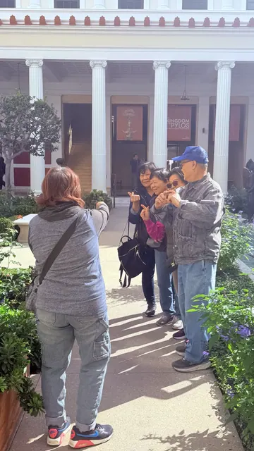 Residents happily posing for photos along a garden walkway