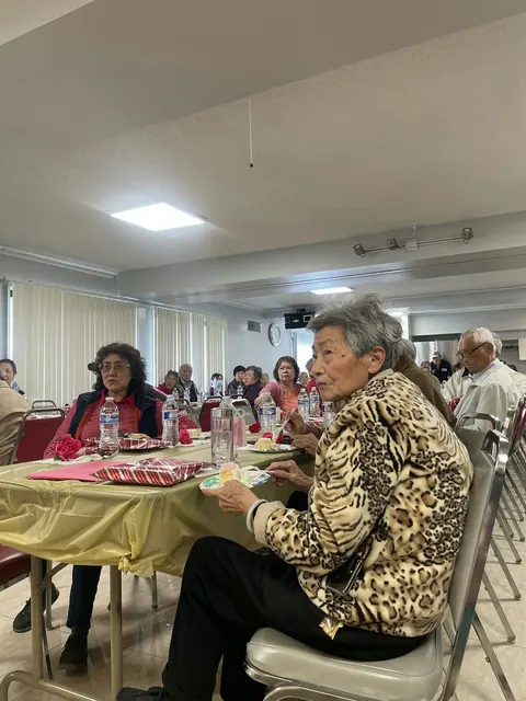 Residents enjoying refreshments at the birthday party