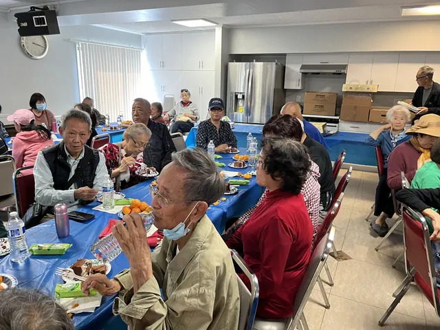 Residents chatting over refreshments at the birthday party