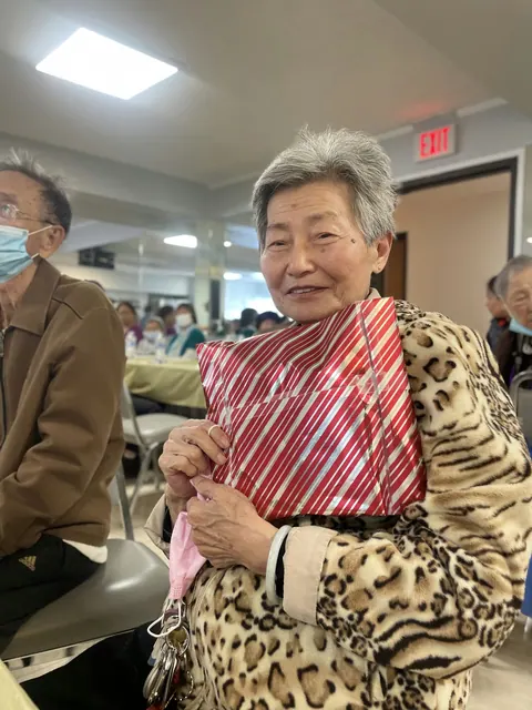 A resident holding a gift at the birthday party