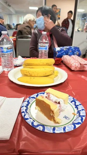 Cake, bananas, and refreshments served at the birthday party