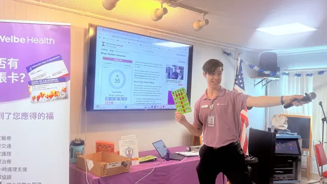 The presenter holding a Bingo card while leading the game