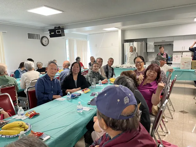 Residents enjoying snacks and fruit at the birthday party