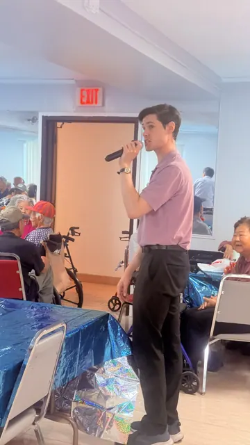 The presenter speaking with residents over a microphone