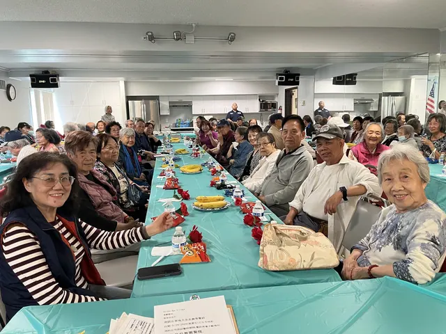A full room of residents celebrating together at the birthday party