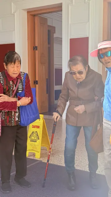 Senior residents walking together outside the galleries