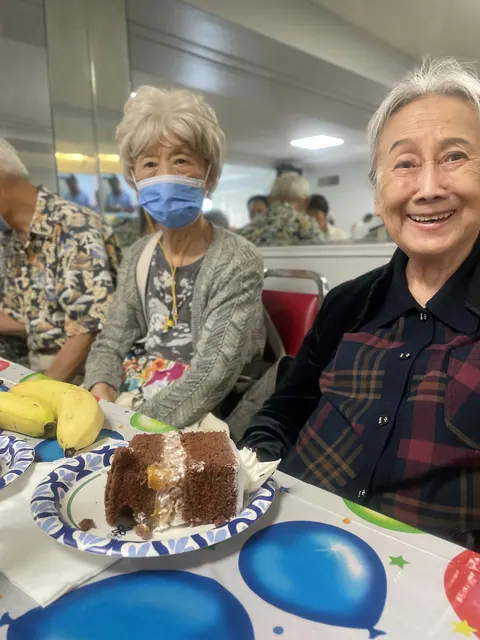 Residents enjoying birthday cake together