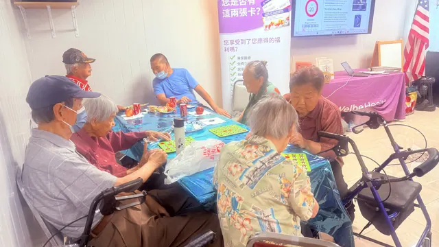 Residents playing Bingo around a table