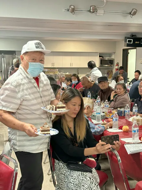 A volunteer serving slices of birthday cake at the party