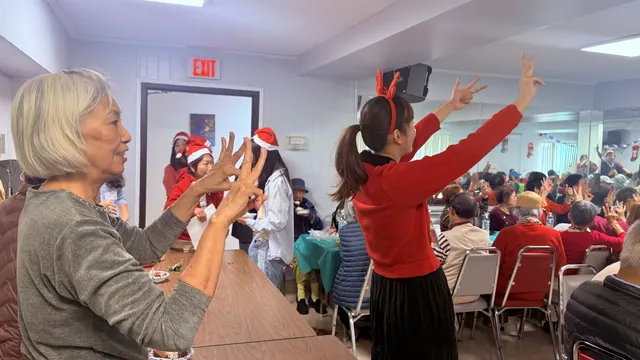 Residents joining in with simple hand movements led by the performers