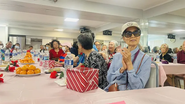 Residents applauding and celebrating at the birthday party