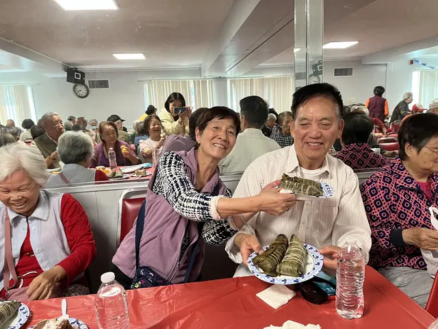 Residents sharing zongzi at the birthday party