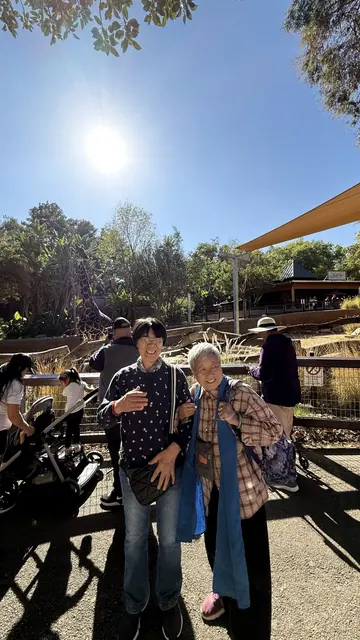 Two residents posing for a photo at the zoo