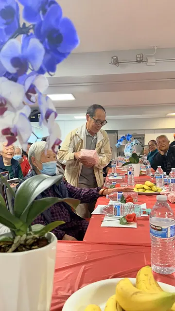 A resident receiving a gift at the birthday party