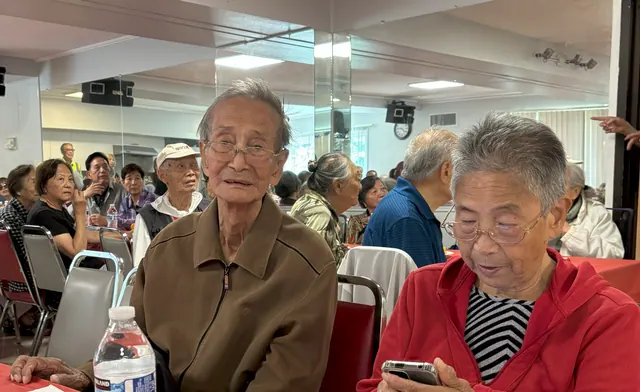 Residents gathered in the activity room for the birthday and Dragon Boat Festival celebration