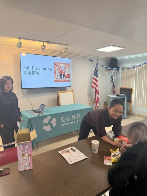 Presenter interacting warmly with residents at the fall prevention seminar