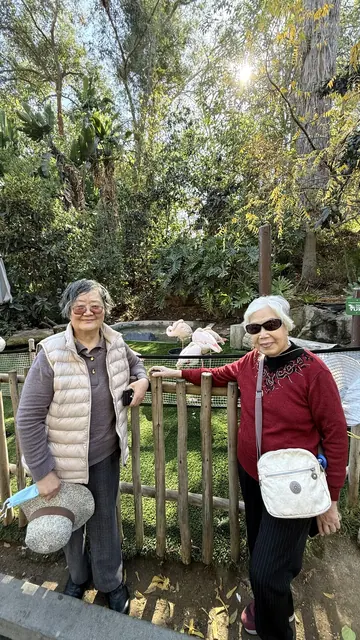 Two residents posing by an exhibit fence